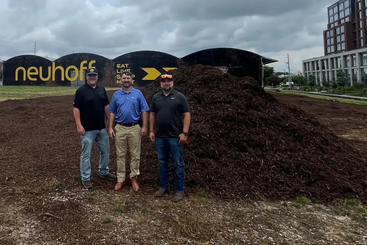 Project team beside donated recycled wood mulch at Neuhoff Dog Park in Nashville.